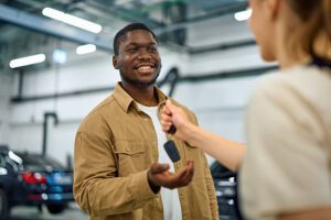 Donor handing over car keys after comparing top rated car donation charities